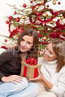Two smiling women with Christmas present