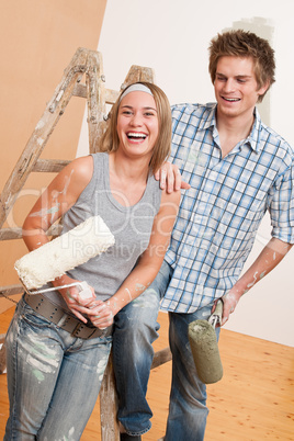 Home improvement: Young couple painting wall