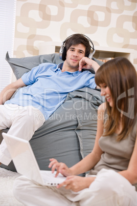 Student - Happy teenager with laptop and headphones