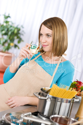 Cooking - Young woman with spaghetti and wine