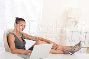 Female manager working with legs up