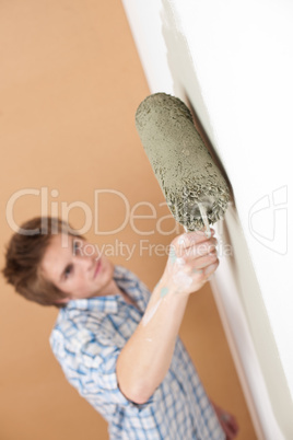 Home improvement: Young man with paint roller