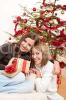 Two smiling women with Christmas present