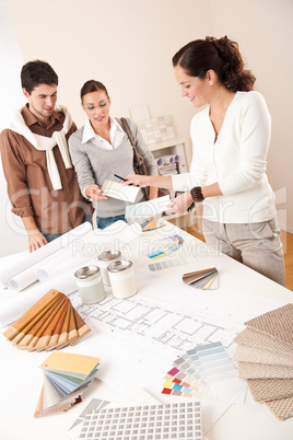 Female interior designer with two clients at office