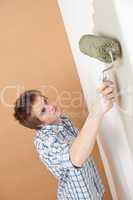 Home improvement: Young man with paint roller