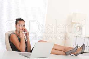 Female manager working with legs up