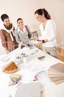 Female interior designer with two clients at office