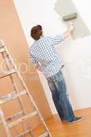 Home improvement: Young man with paint roller