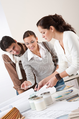 Female interior designer with two clients at office