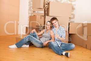 Moving house: Happy man and woman celebrating