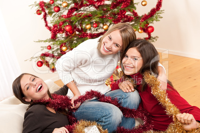 Three cheerful women having fun on Christmas