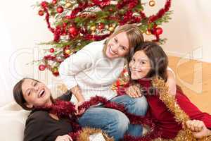 Three cheerful women having fun on Christmas