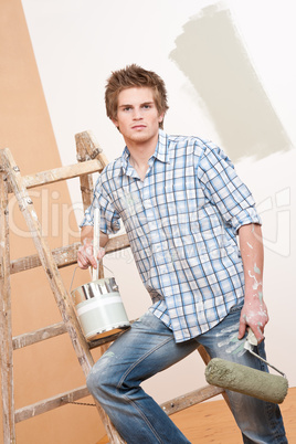 Home improvement: Young man with paint roller