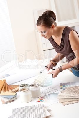 Young female designer working with color swatches