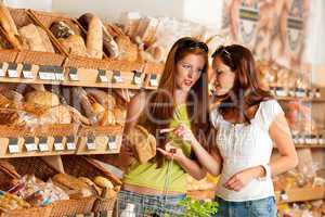 Grocery store: Two women choosing bread