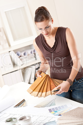 Young female designer with wooden color swatches