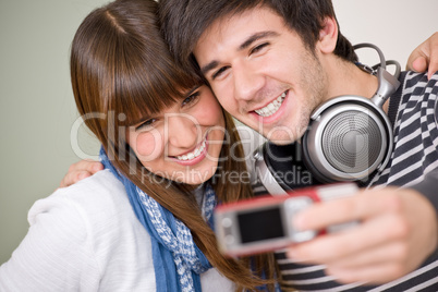 Students - happy teenage couple taking photo with camera