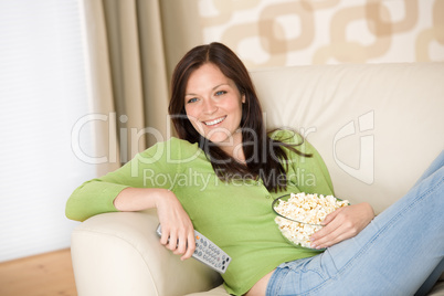Woman pointing with television remote control