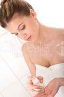 Body care series - young woman applying lotion