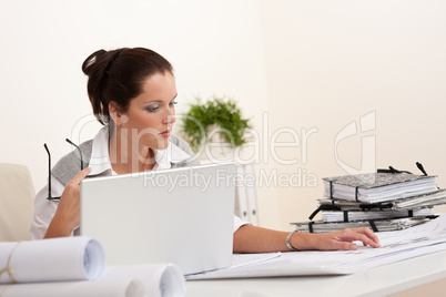 Female architect with laptop sitting
