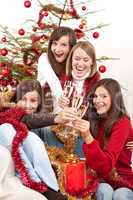 Four young woman on Christmas with champagne