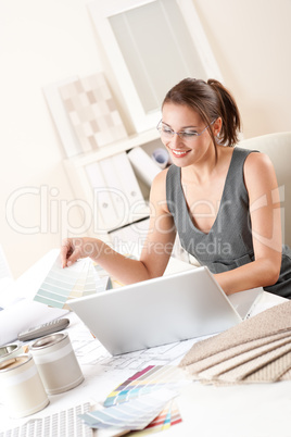 Female interior designer working holding color swatches