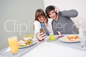 Student cafeteria - teenage couple having fun with music