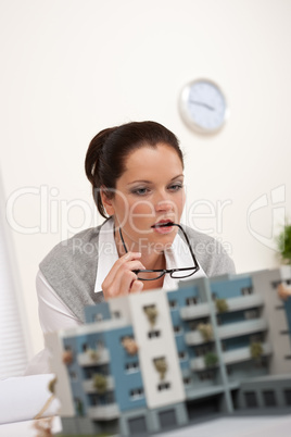 Portrait of female architect with architectural model
