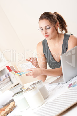 Young female designer working at office with laptop