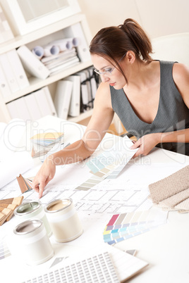 Female interior designer working with color swatch
