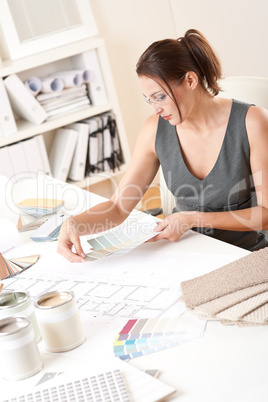 Female interior designer working with color swatch