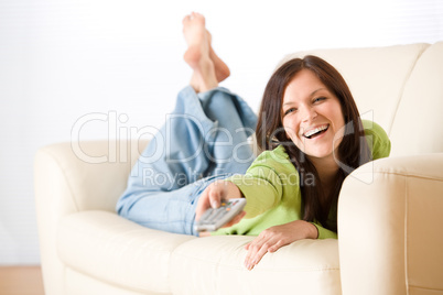 Cheerful woman switch television in living room