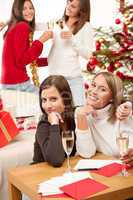 Four smiling women with glass of champagne on Christmas