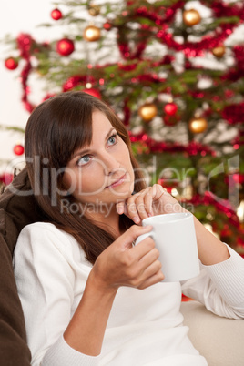 Attractive brunette in front of Christmas tree