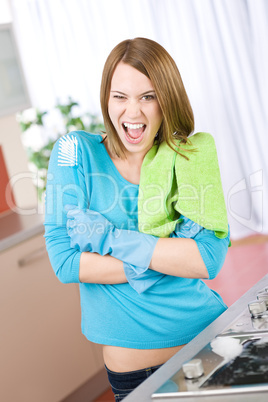 Young woman cleaning stove in kitchen