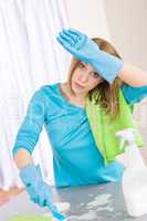 Tired woman cleaning kitchen