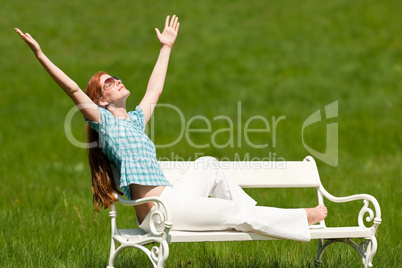 Red hair woman enjoying sun in spring