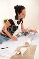 Attractive female architect watching plans