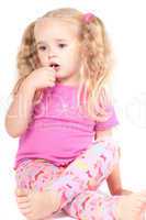 Little cute girl in studio eating candy