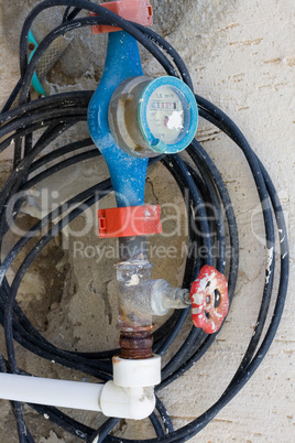 Old dirty water meter and rusting valve