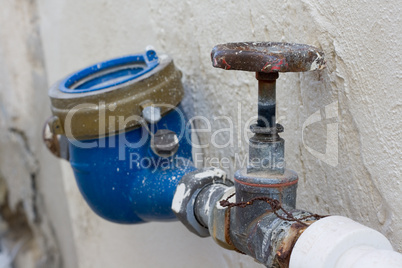 Rusting old water valve with water meter