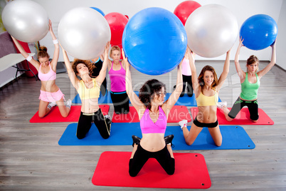 group of people doing pilates in a gym