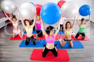 group of people doing pilates in a gym