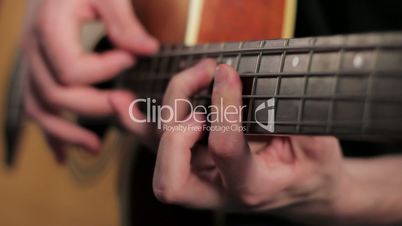 Man playing acoustic bass in studio, shallow depth of field