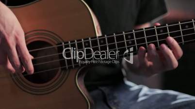 Close up of man playing acoustic bass, dolly shot