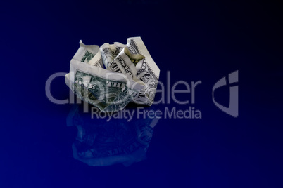 Crumpled dollar isolated on blue