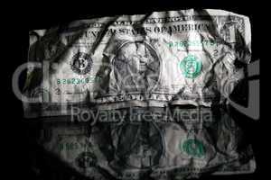 Crumpled dollar isolated on black