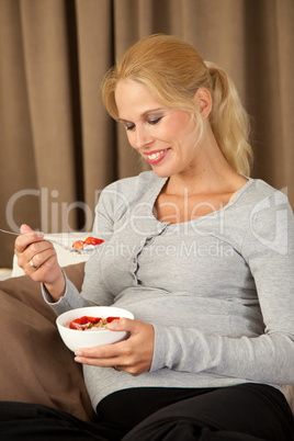 Beautiful pregnant woman eating healthy