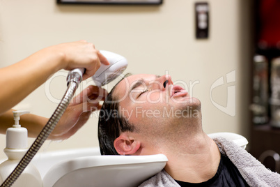 man having his hair washed
