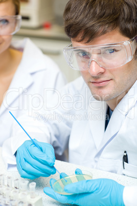 male scientist holding samples